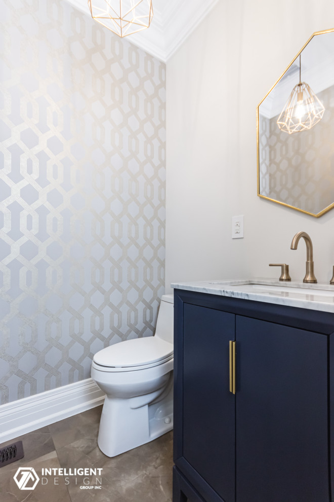 Medium sized classic cloakroom in Toronto with beaded cabinets, blue cabinets, a one-piece toilet, beige walls, porcelain flooring, a submerged sink, marble worktops, brown floors, grey worktops and a freestanding vanity unit.