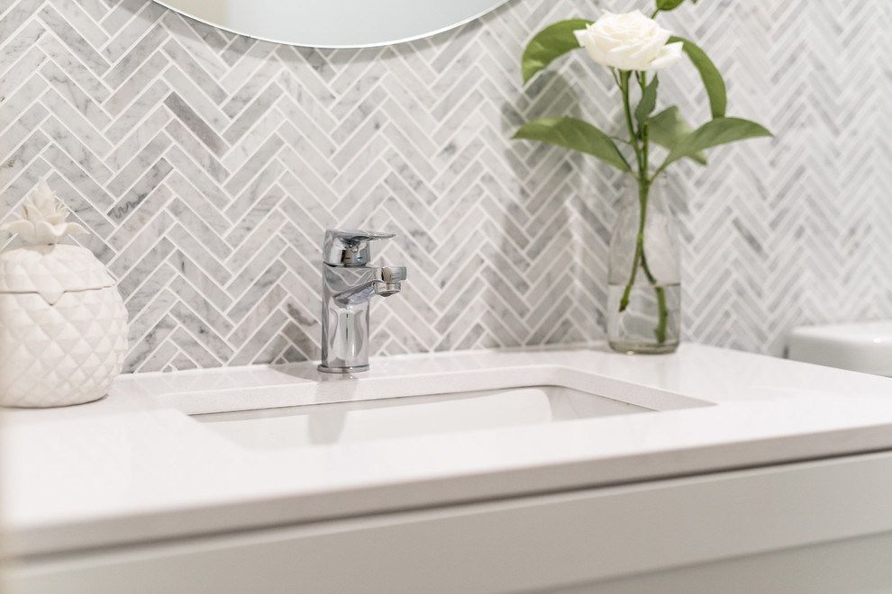 This is an example of a small shabby-chic style master bathroom in Perth with shaker cabinets, white cabinets, an open shower, a one-piece toilet, multi-coloured tile, mosaic tile, multi-coloured walls, porcelain floors, an undermount sink, solid surface benchtops, grey floor and white benchtops.
