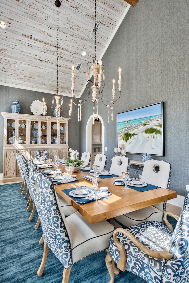 Photo of a beach style dining room in Other with grey walls, medium hardwood floors and brown floor.