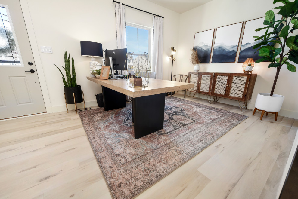 Large modern home office in Other with white walls, vinyl flooring, a freestanding desk and beige floors.