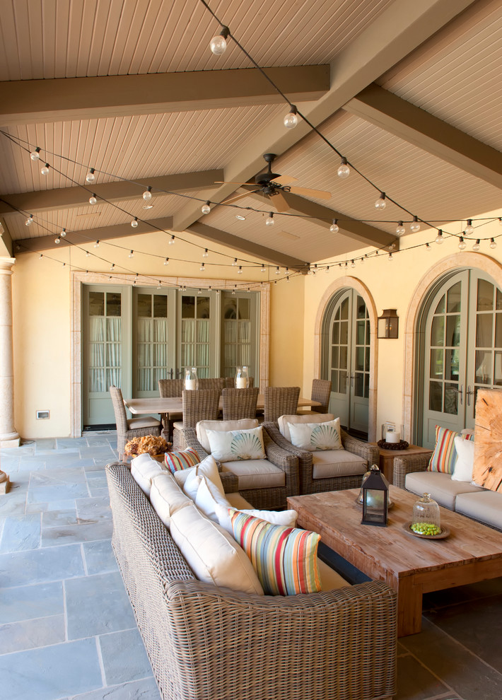 This is an example of a mediterranean verandah in Other with a roof extension.