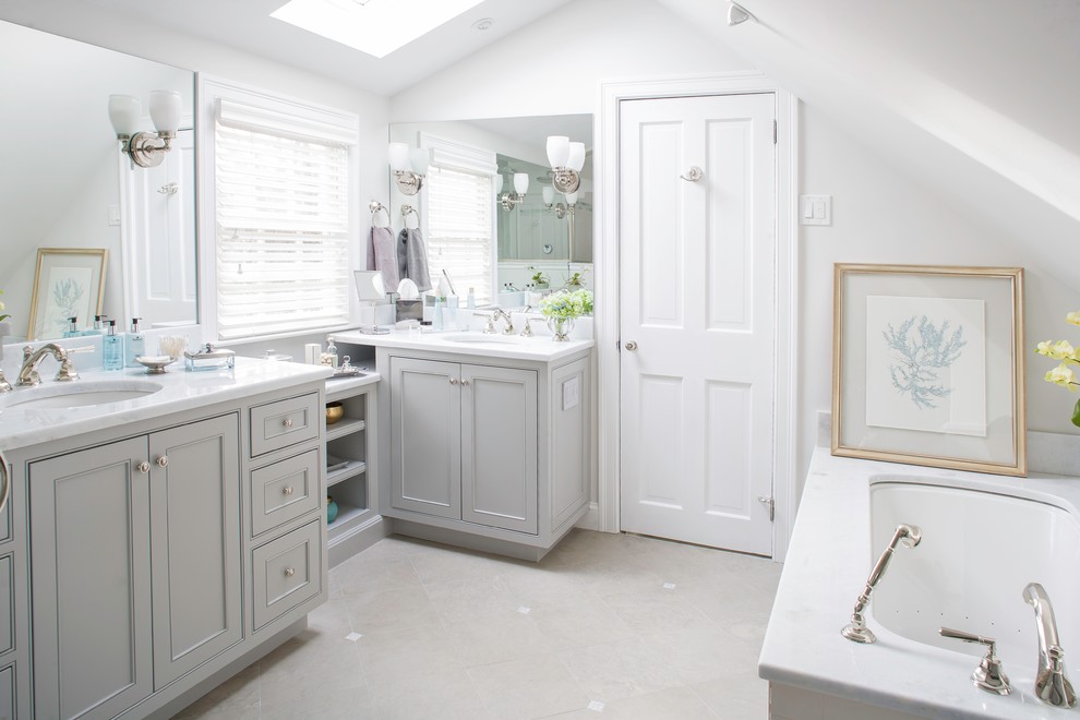 This is an example of a large traditional master bathroom in Bridgeport with marble benchtops, recessed-panel cabinets, grey cabinets, a drop-in tub, an alcove shower, gray tile, white tile, subway tile, white walls, ceramic floors and an undermount sink.