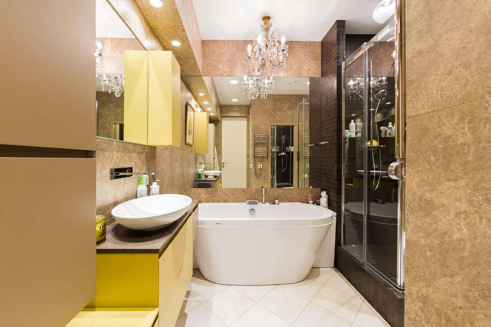 Inspiration for a small contemporary master bathroom in Saint Petersburg with yellow cabinets, a freestanding tub, an alcove shower, brown tile, porcelain tile, porcelain floors, beige floor, a sliding shower screen and a vessel sink.