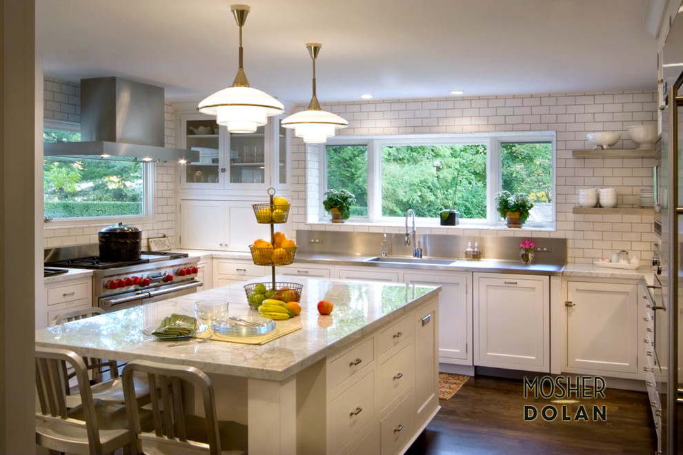 Example of a mid-sized u-shaped medium tone wood floor enclosed kitchen design in Detroit with an integrated sink, recessed-panel cabinets, white cabinets, granite countertops, white backsplash, ceramic backsplash, stainless steel appliances and an island