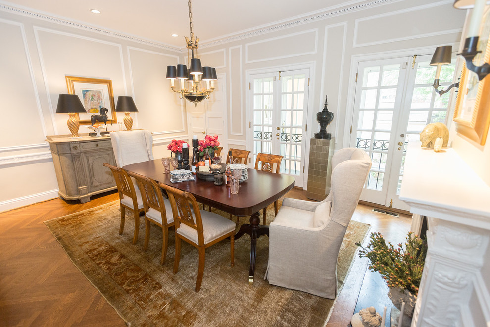 Large transitional medium tone wood floor and brown floor enclosed dining room photo in DC Metro with gray walls, a standard fireplace and a plaster fireplace