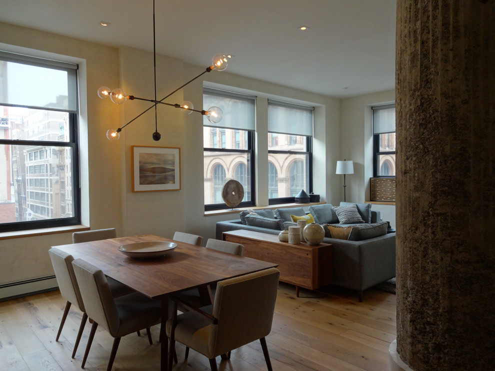 Contemporary dining room in New York with light hardwood floors.
