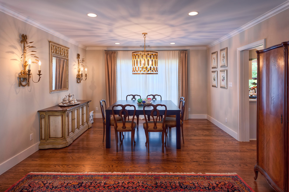 This is an example of a traditional dining room in Austin with beige walls and dark hardwood floors.