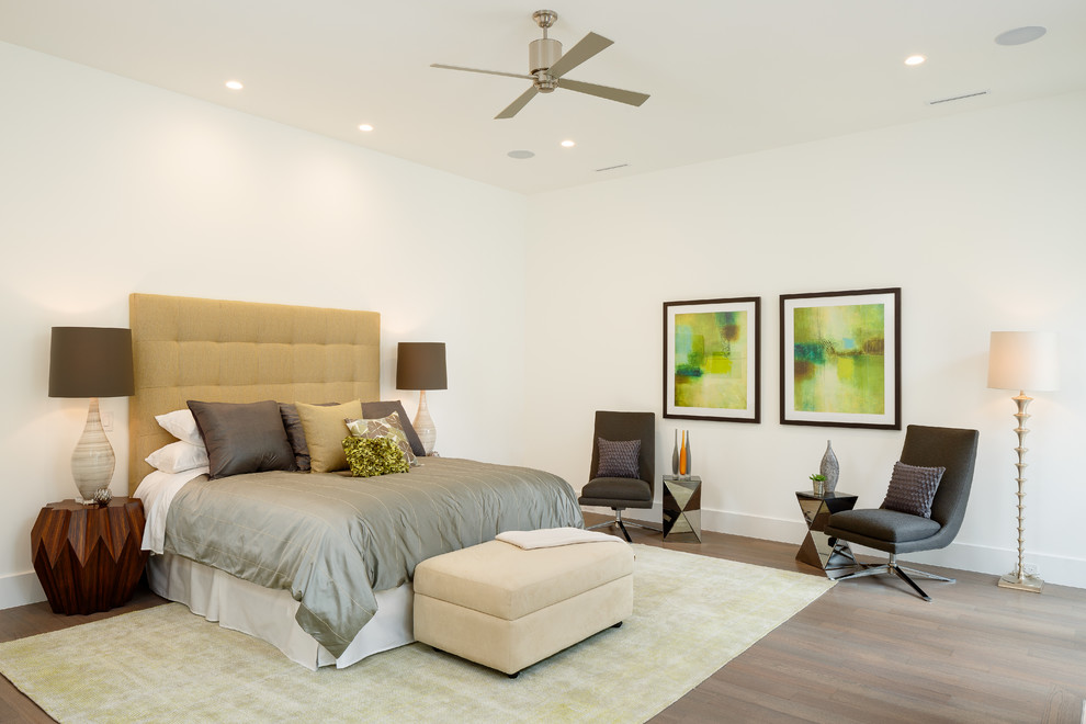 Photo of a transitional bedroom in Dallas with white walls and medium hardwood floors.