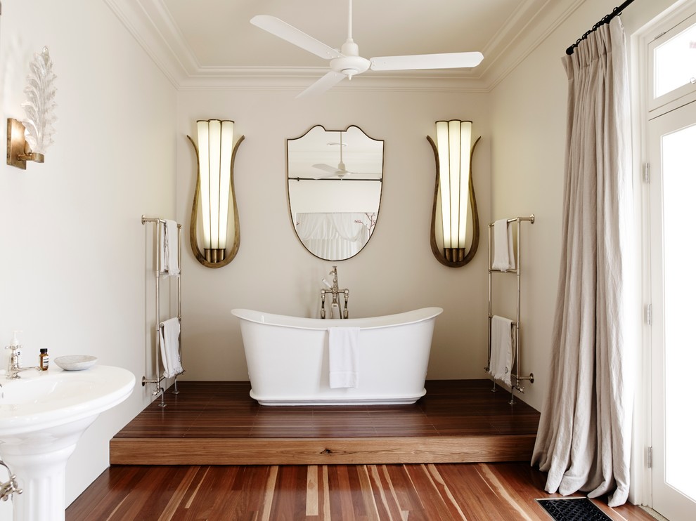 This is an example of a large transitional master bathroom in London with a freestanding tub.