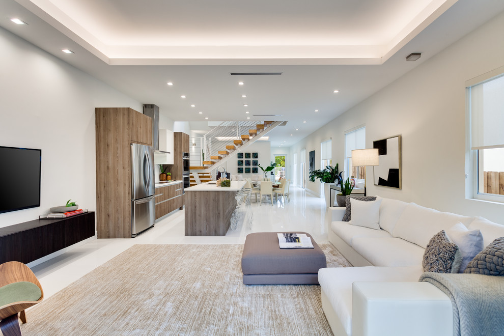 Design ideas for a large contemporary formal open concept living room in Miami with white walls, ceramic floors, no fireplace, a wall-mounted tv and white floor.