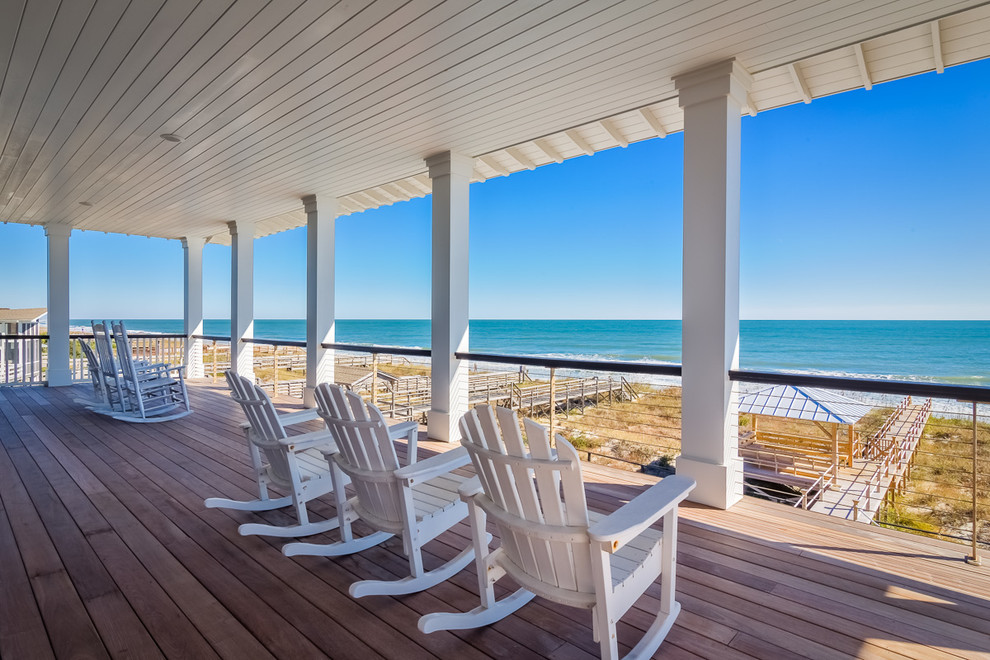 Photo of a beach style balcony in Charleston with a roof extension.