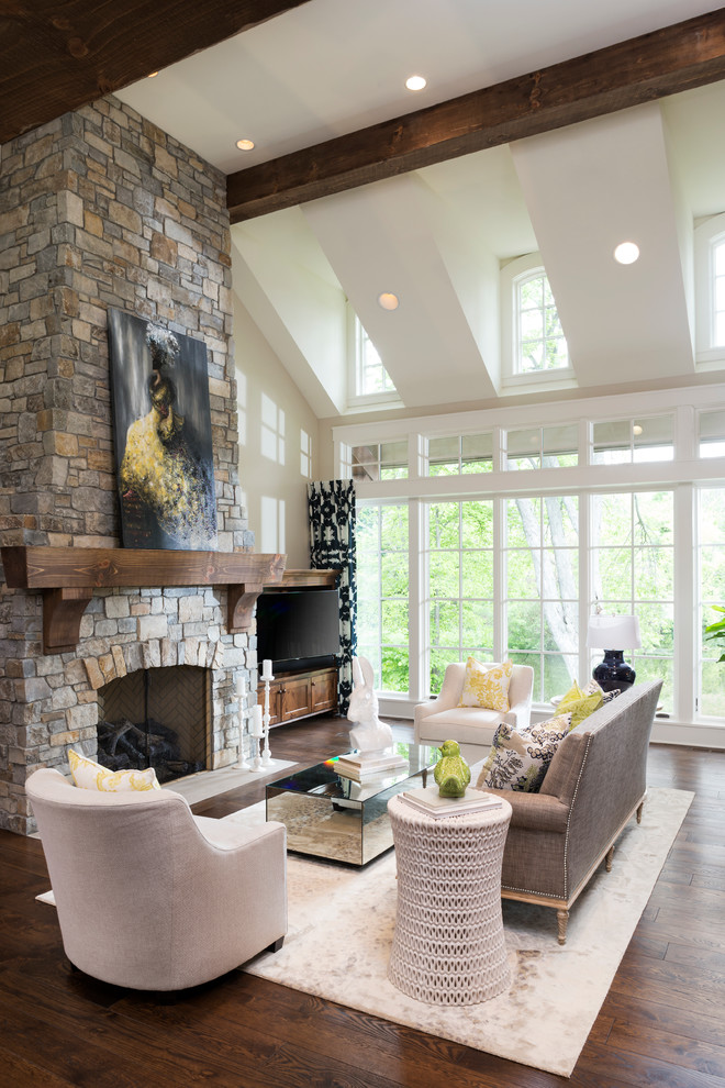 Photo of a large formal open concept living room in Minneapolis with beige walls, a standard fireplace, a stone fireplace surround, dark hardwood floors and brown floor.