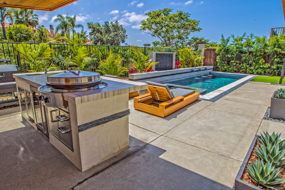 Photo of a small contemporary backyard patio in San Diego with concrete slab and a pergola.