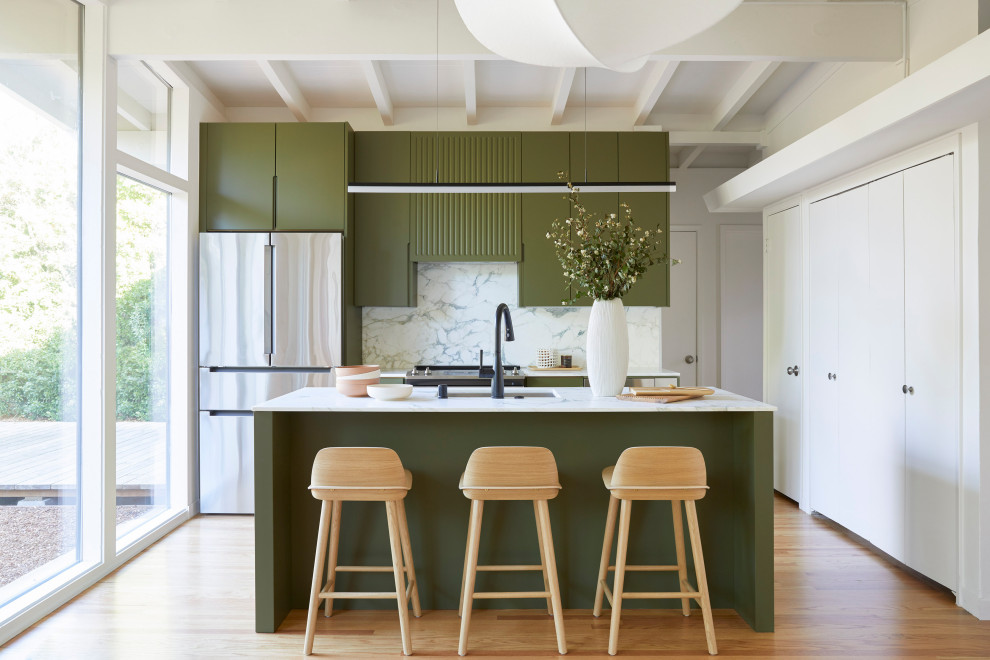 Design ideas for a small retro single-wall open plan kitchen in San Francisco with a submerged sink, flat-panel cabinets, green cabinets, marble worktops, white splashback, marble splashback, stainless steel appliances, medium hardwood flooring, an island, brown floors, white worktops and exposed beams.