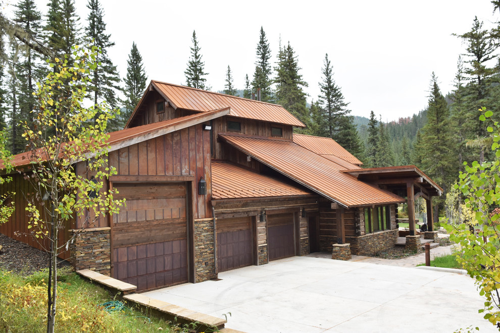 Inspiration for a mid-sized country two-storey brown house exterior in Other with mixed siding and a metal roof.