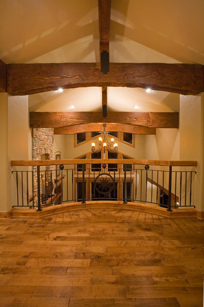 Mid-sized mountain style medium tone wood floor foyer photo with beige walls and a medium wood front door
