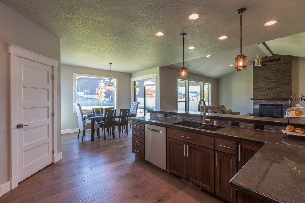 Inspiration for a mid-sized transitional l-shaped dark wood floor and brown floor open concept kitchen remodel in Seattle with a double-bowl sink, recessed-panel cabinets, dark wood cabinets, granite countertops, stainless steel appliances and an island