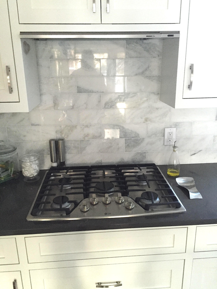 Transitional kitchen photo in Minneapolis with shaker cabinets, white cabinets, solid surface countertops, gray backsplash and stone tile backsplash