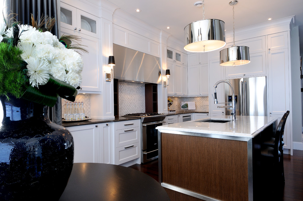 Eat-in kitchen - mid-sized transitional l-shaped dark wood floor eat-in kitchen idea in Calgary with an undermount sink, recessed-panel cabinets, white cabinets, quartz countertops, multicolored backsplash, mosaic tile backsplash, stainless steel appliances and an island