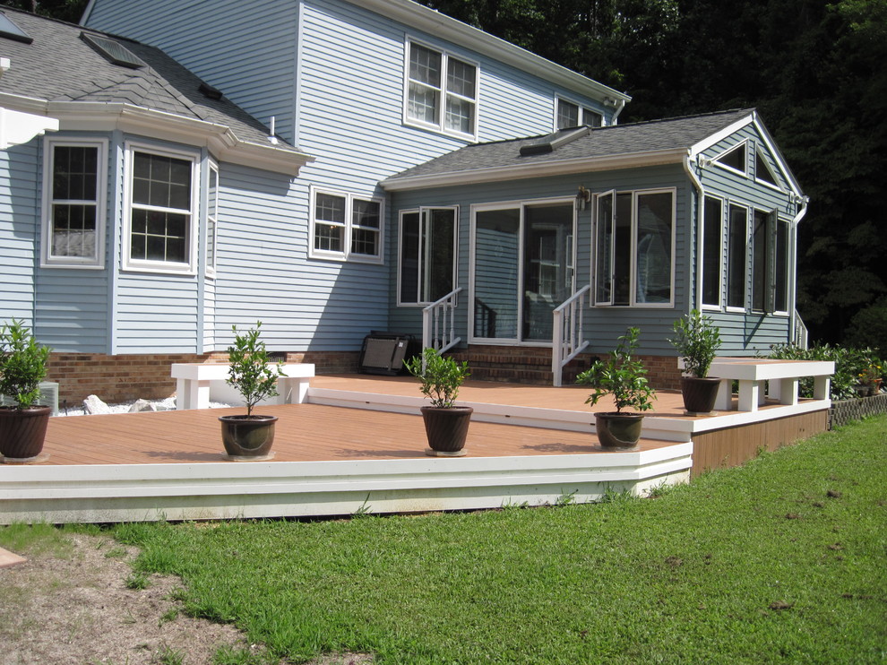 Inspiration for a mid-sized transitional backyard deck remodel with decking and a pergola