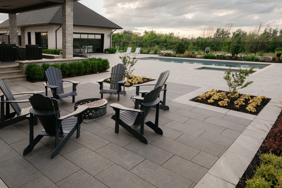 Inspiration for a contemporary backyard patio in Toronto with tile and no cover.