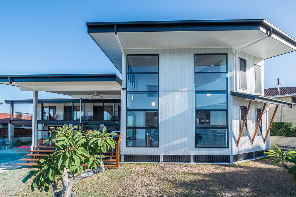 Large contemporary two-storey white exterior in Gold Coast - Tweed with wood siding and a flat roof.