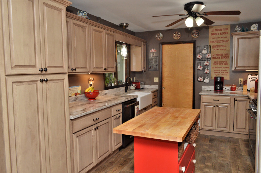 Photo of a mid-sized country galley eat-in kitchen in Other with a farmhouse sink, raised-panel cabinets, beige cabinets, quartzite benchtops, black appliances, laminate floors, with island, brown floor, brown benchtop and exposed beam.