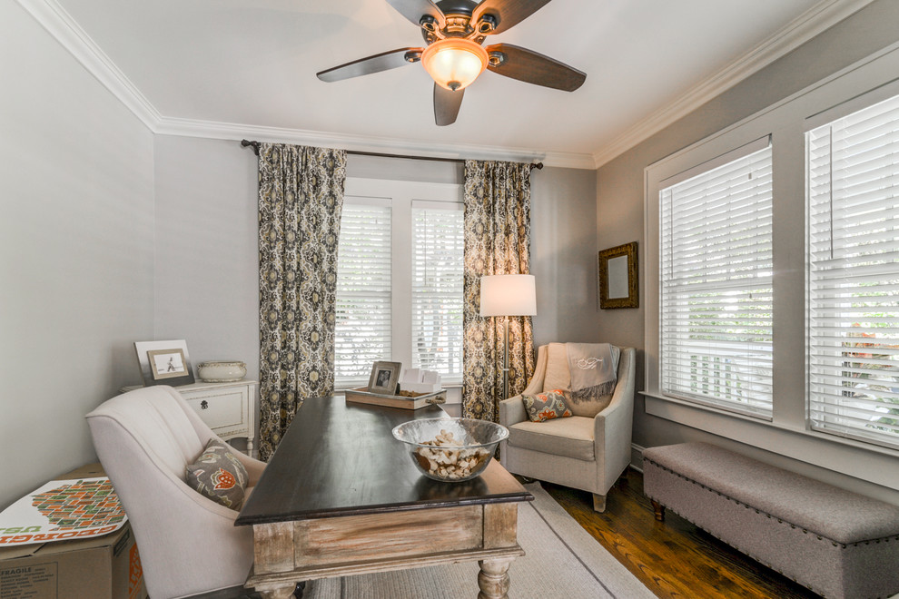 This is an example of a small classic study in Atlanta with grey walls, medium hardwood flooring, no fireplace, a freestanding desk and brown floors.