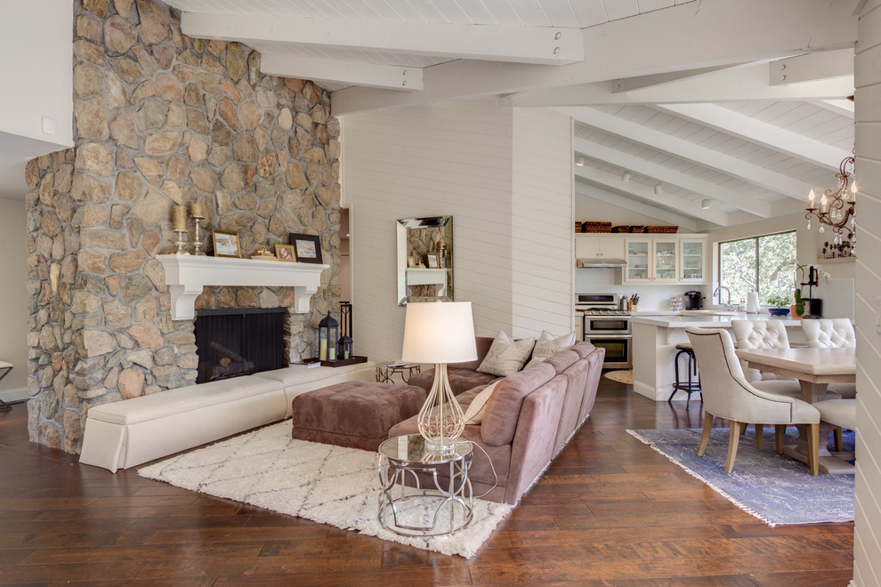 Mid-sized country open concept living room in San Francisco with white walls, medium hardwood floors, a standard fireplace and a stone fireplace surround.