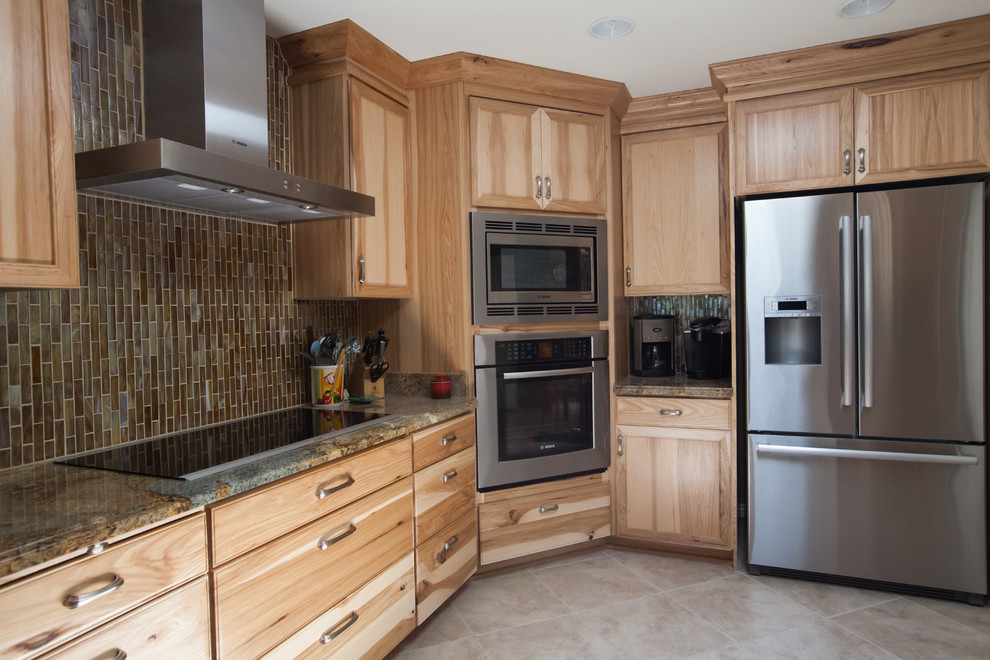 Inspiration for a large transitional galley ceramic tile enclosed kitchen remodel in Phoenix with an undermount sink, recessed-panel cabinets, light wood cabinets, granite countertops, brown backsplash, glass tile backsplash and stainless steel appliances