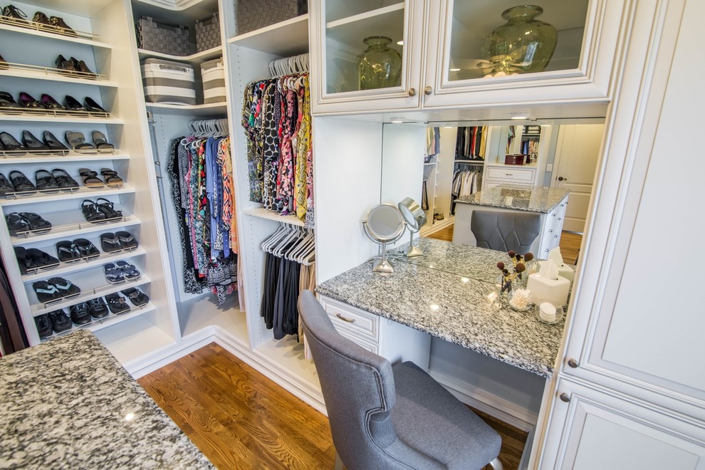 Large traditional gender-neutral walk-in wardrobe in Orange County with open cabinets, white cabinets, brown floor and medium hardwood floors.