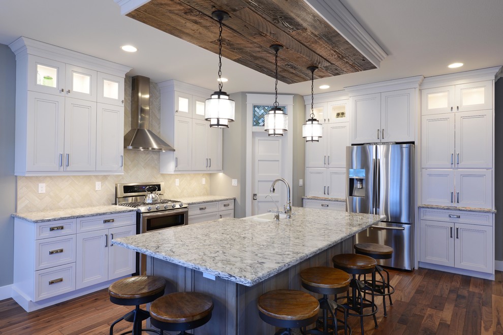 Example of a large minimalist medium tone wood floor eat-in kitchen design with a double-bowl sink, recessed-panel cabinets, white cabinets, quartzite countertops, multicolored backsplash, ceramic backsplash, stainless steel appliances and an island