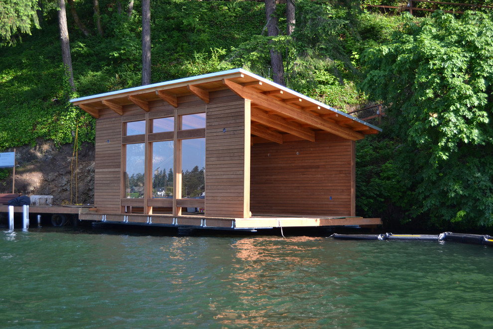 This is an example of a small contemporary detached one-car boathouse in Portland.