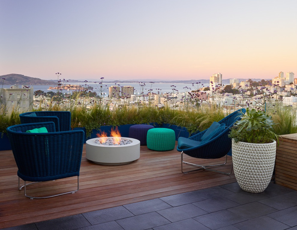 Photo of a large contemporary rooftop deck in San Francisco with a fire feature and no cover.