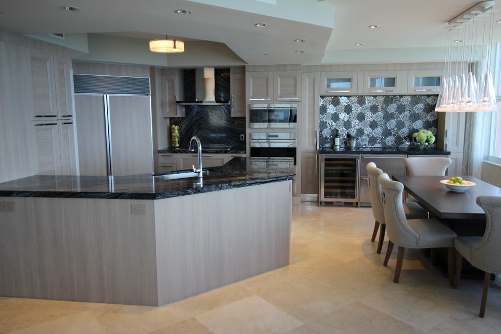 This is an example of a mid-sized contemporary u-shaped eat-in kitchen in Miami with a single-bowl sink, recessed-panel cabinets, beige cabinets, marble benchtops, grey splashback, stone slab splashback, panelled appliances, travertine floors and a peninsula.