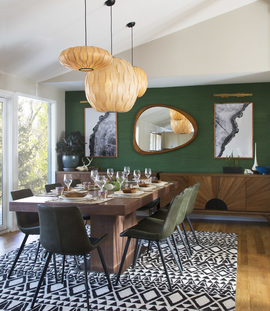 Kitchen/dining room combo - large mid-century modern medium tone wood floor and brown floor kitchen/dining room combo idea in Denver with green walls