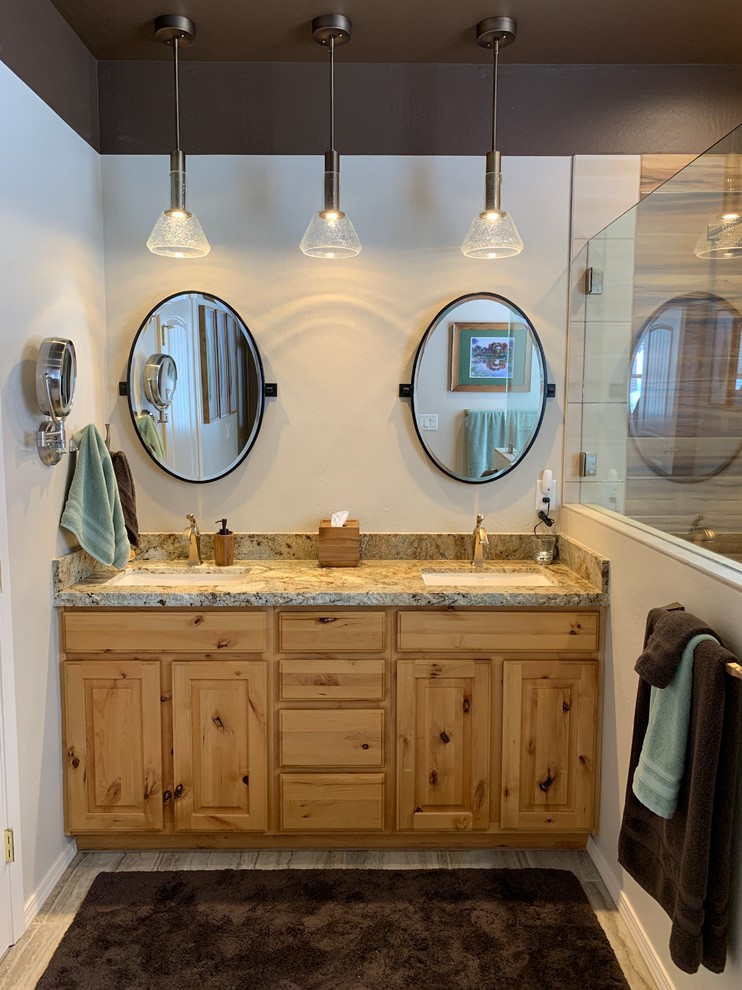 This is an example of a mid-sized transitional master bathroom in Phoenix with raised-panel cabinets, medium wood cabinets, an open shower, beige tile, porcelain tile, beige walls, porcelain floors, an undermount sink, granite benchtops, multi-coloured floor, an open shower and multi-coloured benchtops.