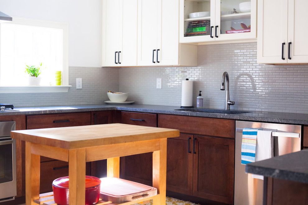 Eat-in kitchen - large transitional u-shaped eat-in kitchen idea in Boston with an undermount sink, shaker cabinets, dark wood cabinets, granite countertops, gray backsplash, ceramic backsplash, stainless steel appliances and a peninsula