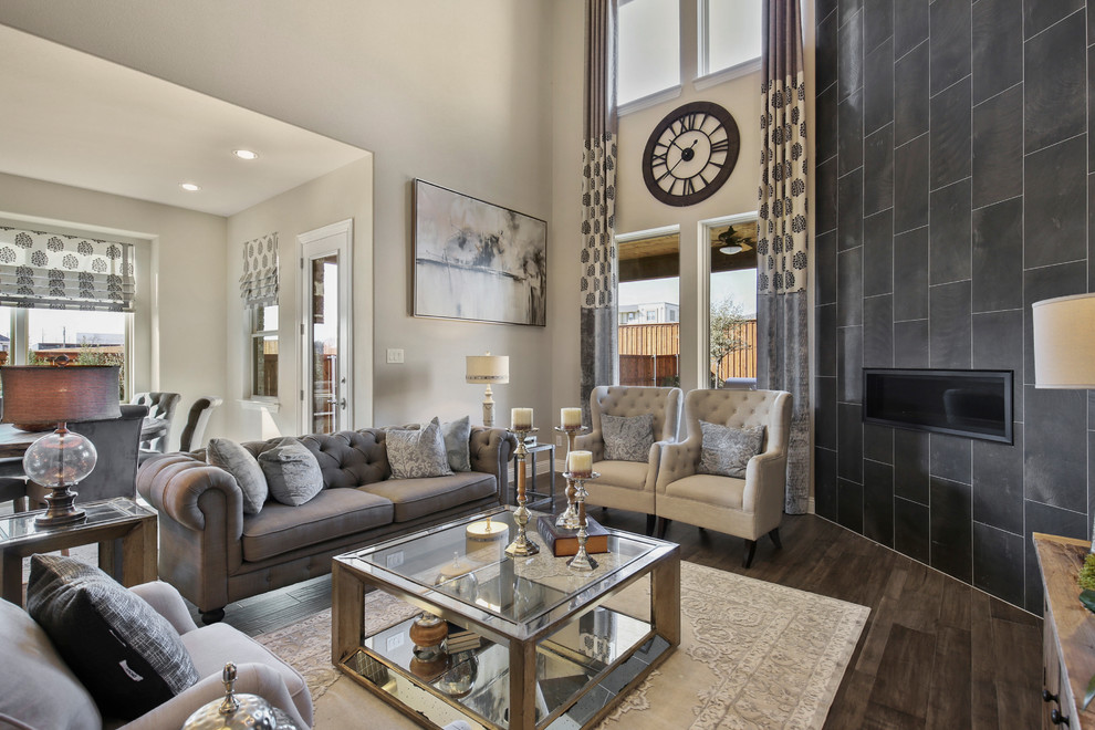 Photo of a large country open concept living room in Dallas with beige walls, dark hardwood floors, a corner fireplace, a tile fireplace surround and brown floor.