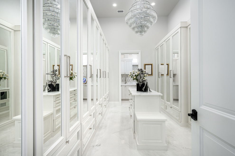 Design ideas for a modern women's walk-in wardrobe in Albuquerque with glass-front cabinets and white cabinets.