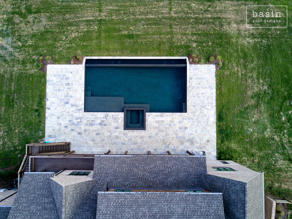Inspiration for a large transitional backyard stone and custom-shaped infinity hot tub remodel in Nashville