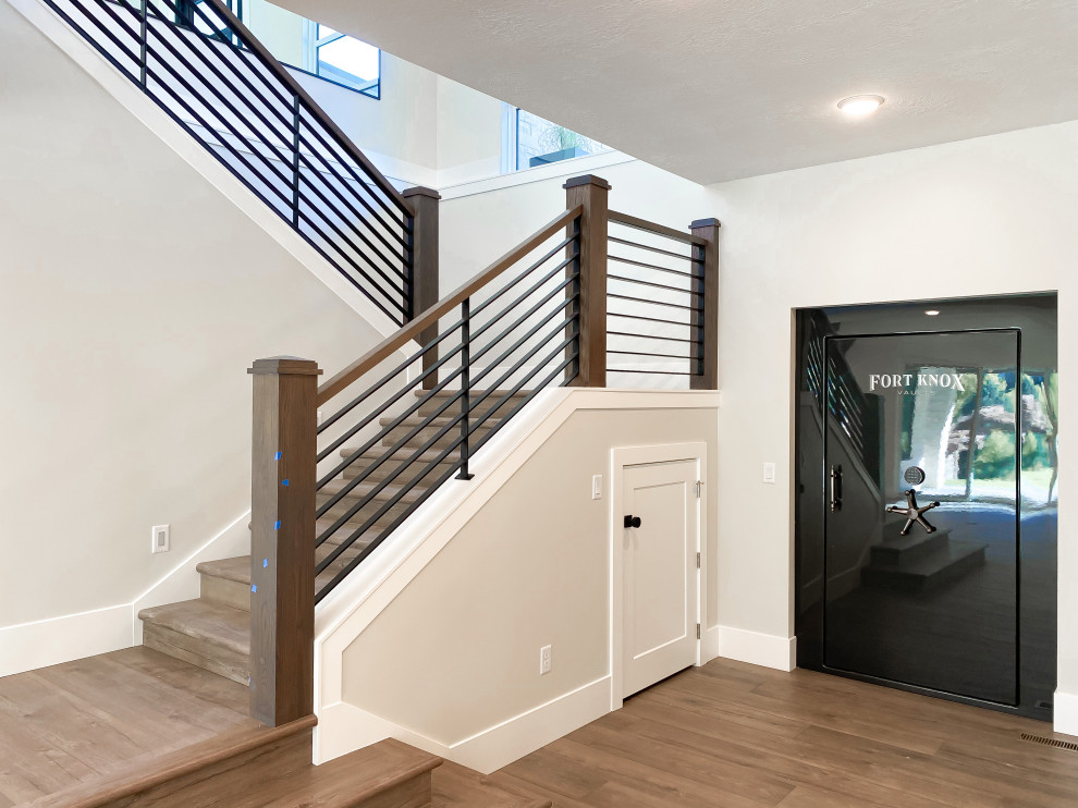 Inspiration for a large contemporary wood u-shaped staircase in Salt Lake City with wood risers and mixed railing.
