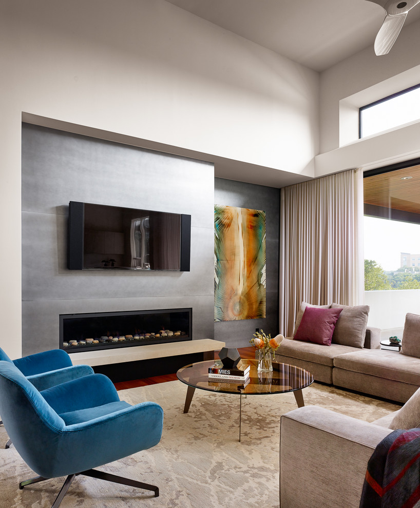 Inspiration for a large contemporary open concept medium tone wood floor living room remodel in Austin with white walls and a wall-mounted tv