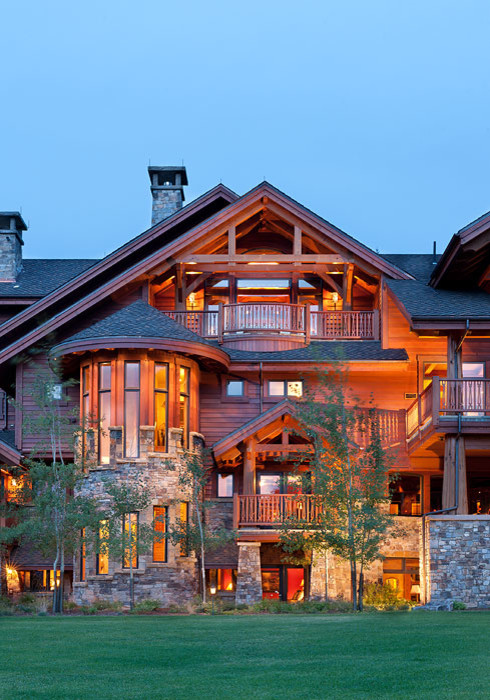 Mountain style brown three-story wood exterior home photo in Other