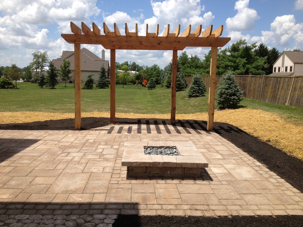 Design ideas for a traditional backyard patio in Columbus with concrete pavers and a pergola.