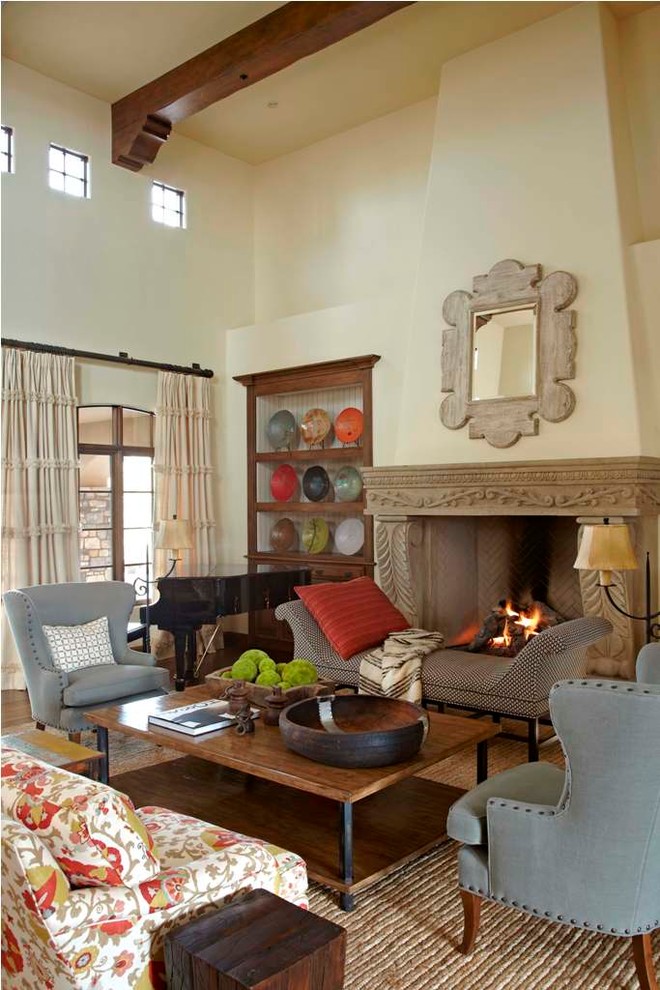 Photo of a mediterranean formal living room in Phoenix with beige walls, a standard fireplace and no tv.