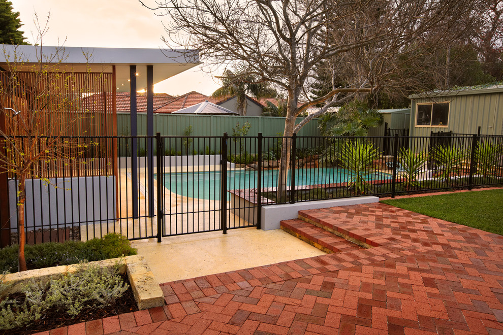 Design ideas for a large traditional backyard full sun outdoor sport court for fall in Perth with brick pavers.