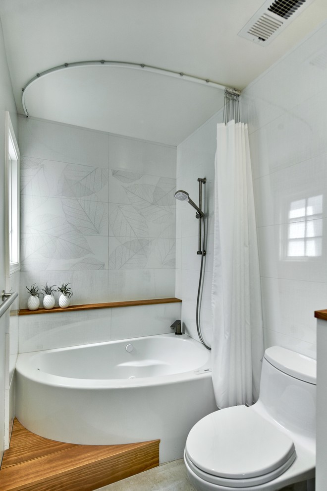 Design ideas for a mid-sized transitional kids bathroom in San Francisco with shaker cabinets, medium wood cabinets, a corner tub, a shower/bathtub combo, a one-piece toilet, white tile, ceramic tile, grey walls, ceramic floors, an undermount sink, granite benchtops, grey floor, a shower curtain and green benchtops.