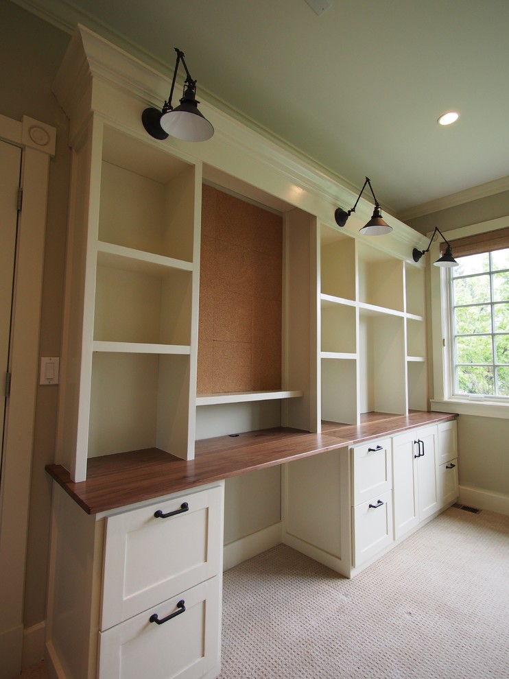 Design ideas for a large arts and crafts home office in Denver with beige walls, carpet and a built-in desk.