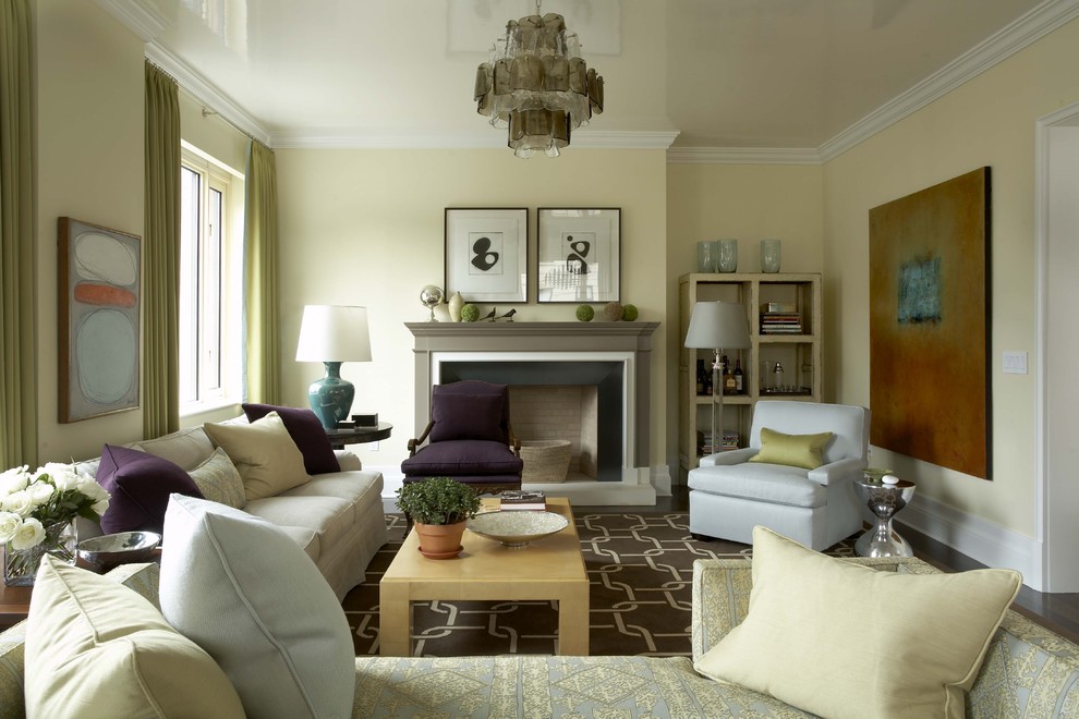 Photo of a transitional formal enclosed living room in New York with yellow walls, a standard fireplace and no tv.